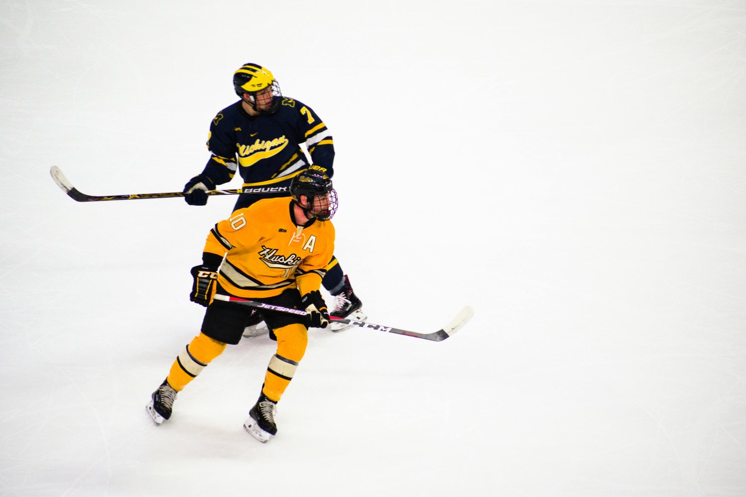 Competitive hockey players battling for position on the ice