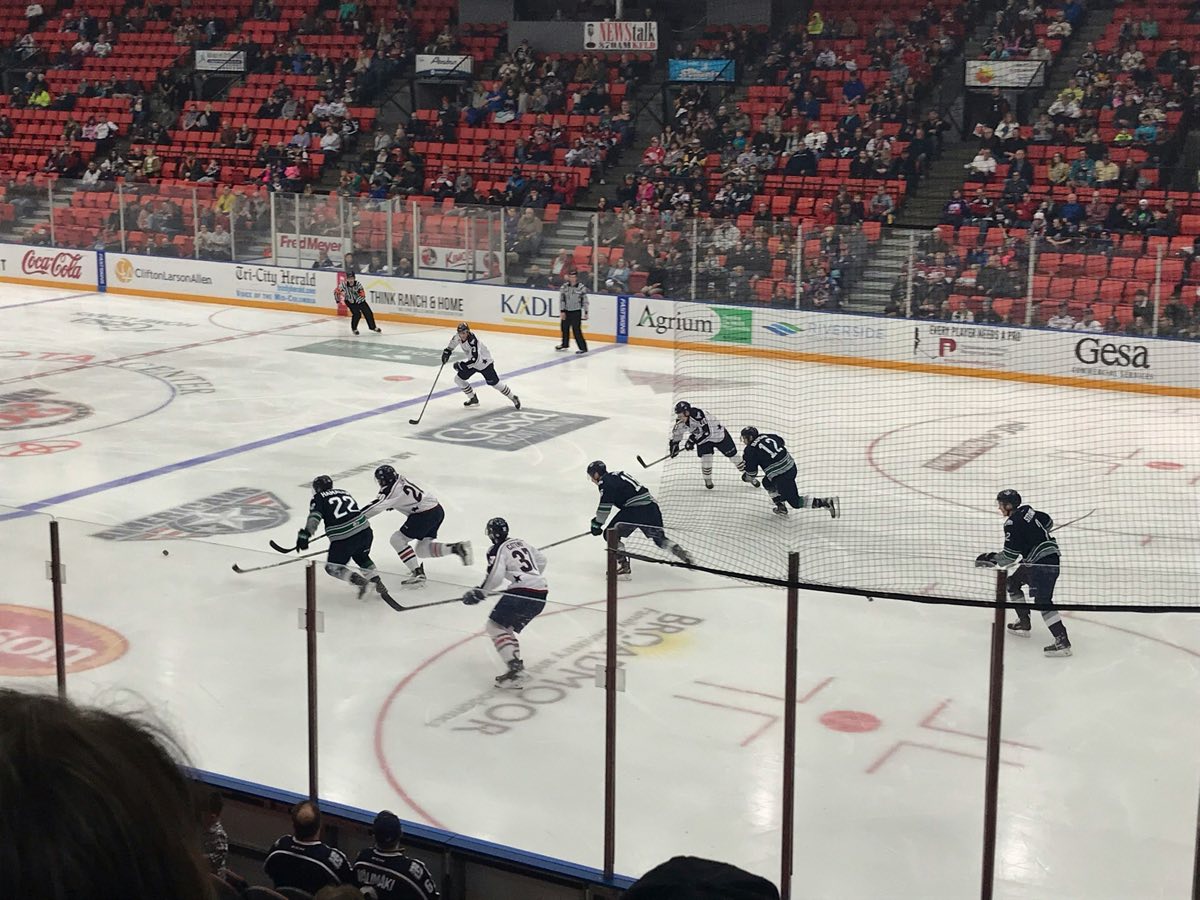 Players in a live game situation during an on-ice session